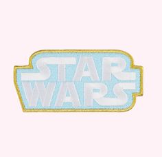 the star wars logo is shown in blue and white on a light pink background with gold trim