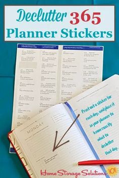 an open planner sticker next to a red pen on top of a blue book