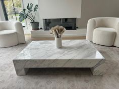 a white marble coffee table in a living room