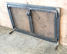 an old metal fire place with two doors