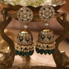 Description Inspired by the opulence of Indian heritage, this regal floral Jhumki is a jewellery essential. An intricate jhumki with floral nuances drop from a distinctive blossom. The deep green enamel detailing reflects the imperial colour of green droplets encircled by light yellow pearls. This magnificent piece stands proudly as testimony to the mastery of artisans. Product Information Metal: 925 Silver with 1.0 microns Gold Plating Length: 7.5 cm Stones: Semi precious jadau Findings: Thread Jadtar Jewellery Earrings, Luxury Bridal Meenakari Earrings For Festivals, Luxury Diamond Meenakari Earrings, Luxury Meenakari Temple Jewelry Chandelier Earrings, Luxury Latkan Pearl Earrings For Festive Occasions, Luxury Bollywood Earrings With Latkans, Luxury Party Jhumkas With Meenakari, Luxury Designer Jhumkas For Diwali, Yellow Colour Earrings