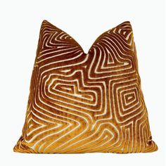 a brown and white pillow with wavy lines on the front, against a white background