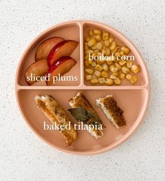 a plate that has different types of food on it, including corn, sliced plums and baked beans