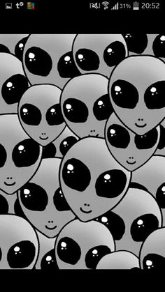 many black and white alien heads are in the middle of an image that looks like they have eyes