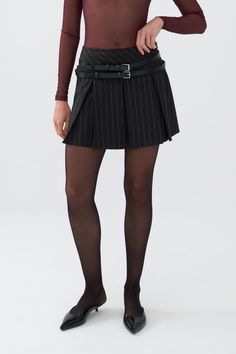 Elevate your wardrobe with Nocturne's women's mini skirt, a fashion-forward piece that combines utility and style. Featuring a slim fit, full lining, no pockets, a concealed side zipper, and a pleated design with a unique double belt detail, this skirt is a versatile statement item. Dry clean Material:63% Polyester, 34% Viscose, 3% Elastane High rise Officially licensed Imported Brand: Nocturne Model Product Size: S Model Size: Height 5'10 / Bust 29.5 in / Waist 23 in / Hips 34 in Runs smaller order one size up. Please check the size chart before placing your order. Double Belt, Fall Trend, Womens Mini Skirts, Faux Leather Mini Skirt, Brand Magazine, Blazer With Jeans, Faux Leather Skirt, Leather Mini Skirts, Pleated Mini Skirt