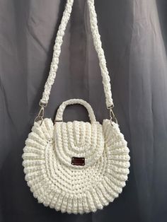 Cream colored crochet handbag with golden hooks for attaching the strap. Lots of space in the bag to store personal belongings. Magnet snap button to close the bag. Unique Width: 38 cm Height : 32 cm Handbag strap: 112 cm long. Everyday Use Crochet Crossbody Bag With Detachable Strap, Everyday Crochet Crossbody Bag With Detachable Strap, Everyday Crossbody Crochet Bag With Detachable Strap, Everyday White Satchel With Round Handle, Crochet Top Handle Bag With Detachable Strap, White Crochet Crossbody Bag With Braided Handles, White Crochet Travel Bag With Top Handle, Everyday Crochet Top Handle Bag With Detachable Strap, Everyday Crochet Bag With Detachable Double Handle