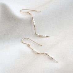 Dainty pearl chain dangle earrings. They are so simple and minimal that they would go with any outfit! Every piece is handcrafted in NYC, and pearls are natural, so shapes and colors may be slightly different from each other. These earrings will be made for you after the order is placed. The item will either be packaged in a jewelry pouch or in a jewelry gift box. Perfect as a gift! MATERIALS 14k gold filled Freshwater pearlsSilicone ear nuts DIMENSIONS approx. 2 3/4" (60mm) length Minimalist Long Drop Earrings With Pearl Charm, Dangle Pearl Earrings With Adjustable Chain, Everyday 14k Gold Filled Pearl Chain Earrings, Handmade Minimalist Pearl Earrings For Everyday, Minimalist Pearl Dangle Linear Earrings, Minimalist Handmade Pearl Earrings For Everyday, Minimalist Pearl Drop Dangle Earrings, Minimalist Pearl White Dangle Pearl Earrings, Everyday Long Drop Earrings With Pearl Charm