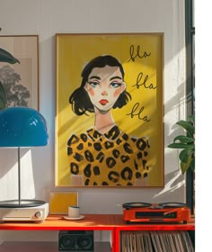 a painting is hanging on the wall next to a table with records and a lamp