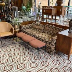 a living room filled with lots of furniture and decor on top of a carpeted floor