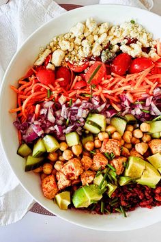 a large bowl filled with lots of different types of food on top of a table