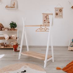 a child's room with white walls and wooden toys on the floor in front of it