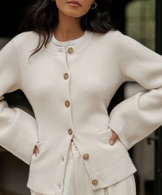 Cooper Cardigan Warm Ivory Featuring a structured hourglass silhouette and a very slight bell sleeve, this chic knit is unlike anything we’ve done before. Ultra-soft wool cashmere and a classic shape are easily styled with everything from wide-leg trousers to your favorite skirt. 70% wool, 30% cashmere. Made in China. Fitted button-down cardigan. | 70% wool, 30% cashmere. Made in China of Peruvian yarn. Fitted button-down cardigan. Dry clean. Fits true to size. | Jenni Kayne Women's Cooper Cardi Structured Cardigan, Sweaters Style, Clean Fits, Clothing Wishlist, Winter Knitwear, Hourglass Silhouette, Casual Chique, Áo Len Cardigan, Slim Sweater