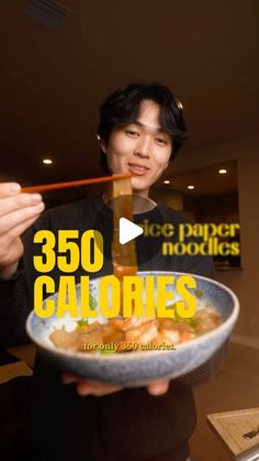 a man holding a bowl of food with chopsticks in his hand and the words 350 calories on it