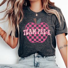 a woman with long hair wearing a shirt that says team prek