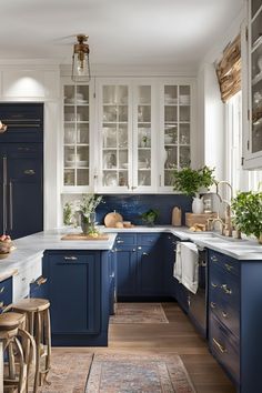 a kitchen with blue cabinets and stools in the center, along with an area rug on the floor