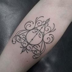 a black and white photo of a tattoo on someone's arm, with the letter f