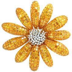 Meticulously hand-crafted with calibré-cut Yellow Sapphire, this blossom is completed with 76.25 cts of yellow sapphire and centered with 1.04 cts of Diamond set in 18k Gold Settings. Diamond quality: VS-SI Clarity F-H Color. Width: 7.0 cm Length: 7.0 cm "We first opened doors in 1980 when it was then situated in the vicinity of the Victory Monument; a small and modest storefront with a couple of counters. From its humble beginnings to where it stands today, our company has proven its abilities Yellow Sapphire Jewelry, Diamond Flower Brooch, Yellow Jewelry, Gold Beauty, Antique Brooches, Diamond Brooch, Royal Jewels, Gold Brooches, Diamond Flower