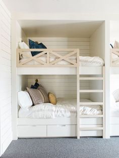 bunk beds in a room with white walls and carpet