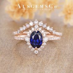 a ring with a blue stone surrounded by white pearls