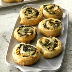 several small pastries are on a tray