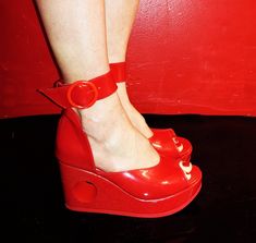 "PEEPHOLE Platform Sandals in Red Patent Handcrafted to order in London Red Sandals with removable wide ankle strap and hole going through Platform at back.  Platform made of wood and covered in red patent leather Genuine leather : upper and platform cover is made of Red patent leather. Wedge height: 1.1\"inches (3cm) at front and 3.1\"inches (8cm) at back Ankle strap is 1.3\"inches (3.3cm) wide and fastens with large red buckle With an arch height of 2\"inches (5cm) these shoes are fitted with Donut Shoes, 70s Mode, 1970s Shoes, Pottery Owl, London Red, Red Sandals, Shoe Company, Shoes Summer, 70s Style