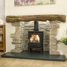 a wood burning stove sitting inside of a living room next to a firewood log