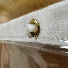 a close up view of the handle on a white piece of furniture with gold hardware