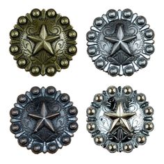 three metal buttons with star designs on the center and one has an ornate design in the middle