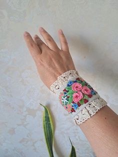 Linen detachable cuff bracelet with Embroidery are an extraordinary accessory that adds elegance to your casual clothes and turn them into haute looks and burst into your linen paradise. This beautiful unique Design linen fabric bracelet is made with embroidered  pink flowers with finishing lace and beads . Button closure. This cuff can be worn like real bracelet. The whole composition has a Boho Chic Style- elegant air and can be the piece of resistance for any outfit. You can wear them like on Bohemian Bracelets For Summer Weddings, Spring Gift Wristlet With Wrist Strap, Elegant Adjustable Decorative Bracelets, Bohemian Summer Wedding Bracelets, Summer Wedding Bohemian Bracelets, Bohemian Embroidered Bracelets For Weddings, Spring Bohemian Cuff Bracelet As Gift, Spring Bohemian Cuff Bracelet For Gift, Elegant Embroidered Bracelets As Gift