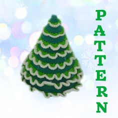 a crocheted christmas tree ornament with snowflakes in the background