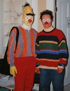 two men in clown costumes standing next to each other