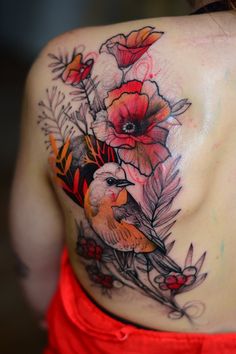 a woman's back with flowers and birds on it