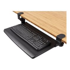 a computer keyboard sitting on top of a wooden desk