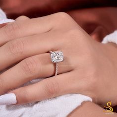 a woman's hand with a diamond ring on it