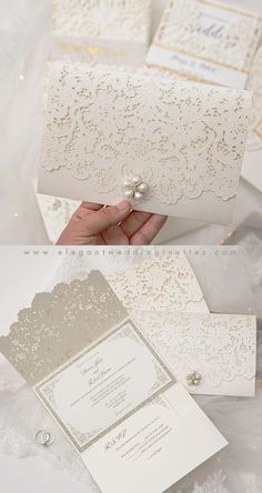 the wedding card is being held up by someone's hand, and there are other cards in front of them