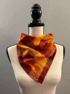 **Ready to Ship** Handmade soft 100% cotton flannel bandana style scarf. Oranges, reds, and yellows in a checkered plaid, dark red leaves embroidered along the edges, and one metal snap. Perfect accessory to keep you warm and stylish for the fall and winter.  Easy to wear with your coat and over a sweater without the bulk of a large scarf. Makes a wonderful gift for yourself or anyone who wants to be cozy! The finished size is approximately 26  inches in length and 13 inches wide, wear it as part of your outfit or as a scarf for those chilly outings! Easy all-day wear without the bulk of a full scarf. This scarf is: -Made of 100% soft cotton flannel in a smoke-free environment. -Machine wash delicate cold. Tumble-dry low. *Fabric may shrink in the dryer* recommend hanging to dry to prevent Casual Cotton Scarves For Fall, Casual Fall Scarves, Cotton Scarves For Fall, Casual One Size Winter Bandana, Casual Winter Bandana, Casual Yellow Scarf For Winter, Red Casual Scarves For Fall, Casual Orange Scarves For Fall, Casual Orange Scarf For Fall