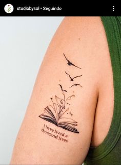 a woman with a book tattoo on her arm and the words i have lived a thousand lives