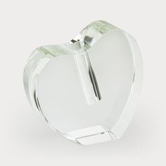 a clear glass heart shaped object on a white background