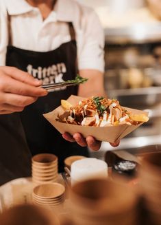 a person in an apron is serving food