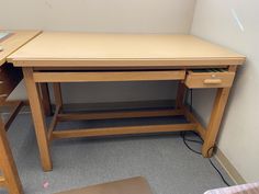 a wooden desk with drawers underneath it