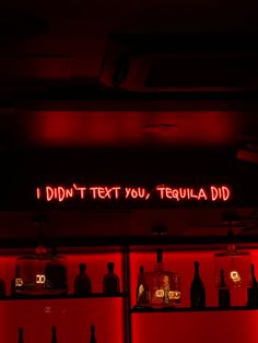 a red neon sign that reads, i didn't text you tequila did