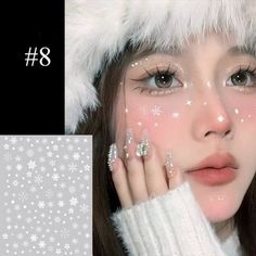 a girl with white snowflakes on her face and hands in front of her face