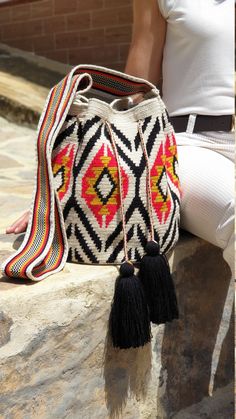 The stunning, one-of-a-kind Wayuu bag is 100% handmade and was carefully crocheted by female artisans from the Wayuu tribe in the desert of Colombia, South America. The versatile crochet crossbody Wayuu bag was created for the woman that values and appreciates true craftsmanship. This particular double thread crochet crossbody represents approximately 10-15 days of work for a single artisan. FREE SHIPPING TO THE US, CANADA AND THE EU -WAYUU CROSSBODY BAG SPECS & SIZING- Material: 100% Acryli Handmade Red Bucket Bag For Travel, Artisan Rectangular Crochet Bag, Handmade Red Bucket Shoulder Bag, Handmade Red Bucket Bag For Daily Use, Artisan Crochet Bag With Weaving, Bohemian Weaving Bucket Bag, Beige Traditional Crochet Bag, Artisan Crochet Bag, Traditional Crochet Bags For Everyday Use