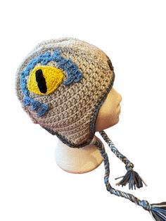 a crocheted hat with an eye on it