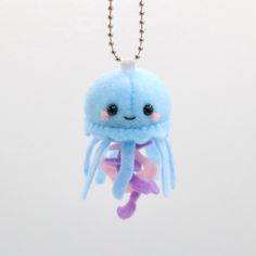 a blue stuffed animal hanging from a ball chain