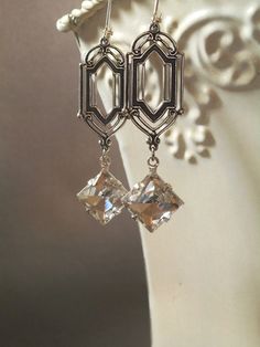 These Art Deco style vintage glass dangles are the perfect earrings for a Great Gatsby themed wedding. They were inspired by the dazzling diamond Art Deco Clip-on Earrings For Formal Occasions, Art Deco Formal Clip-on Earrings, Formal Art Deco Dangle Chandelier Earrings, Art Deco Dangle Chandelier Earrings For Formal Occasions, Art Deco Metal Earrings For Evening, Clip-on Art Deco Earrings For Evening, Art Deco Jewelry For Vintage Events, Silver Art Deco Chandelier Earrings For Evening, Victorian Dangle Earrings For Party