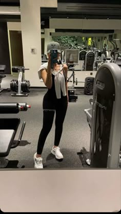 a woman taking a selfie in the gym