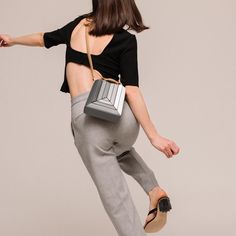 The new Sera Tall Tote is designed to carry your daily essentials, it can easily fit a large phone (like iPhone 15 Pro Max), mini wallet or cardholder, keys, lipstick, etc.Its exterior design is a surrealist dream, reminiscent of a maze-like structure protruding outwards, with sharp, clean lines, and a 3D façade. It has a suede drawstring top, securing your belongings on the go.Folding inwards like an accordion and then stretching outwards to store those last-minute belongings. The Sera Tall Tot Modern Phone Bag With Removable Pouch For Evening, Modern Evening Phone Bag With Removable Pouch, Modern Evening Bag With Card Slots, Modern Evening Box Bag With Mobile Phone Holder, Modern Evening Bags With Card Slots, Modern Phone Bag With Removable Pouch, Modern Square Phone Bag For Everyday Use, Modern Square Phone Bag With Cell Phone Pocket, Modern Office Bag With Card Slots