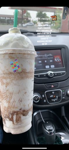 an iced drink sitting on top of a car dashboard