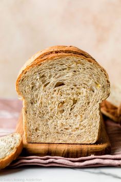 a loaf of bread sitting on top of a wooden cutting board